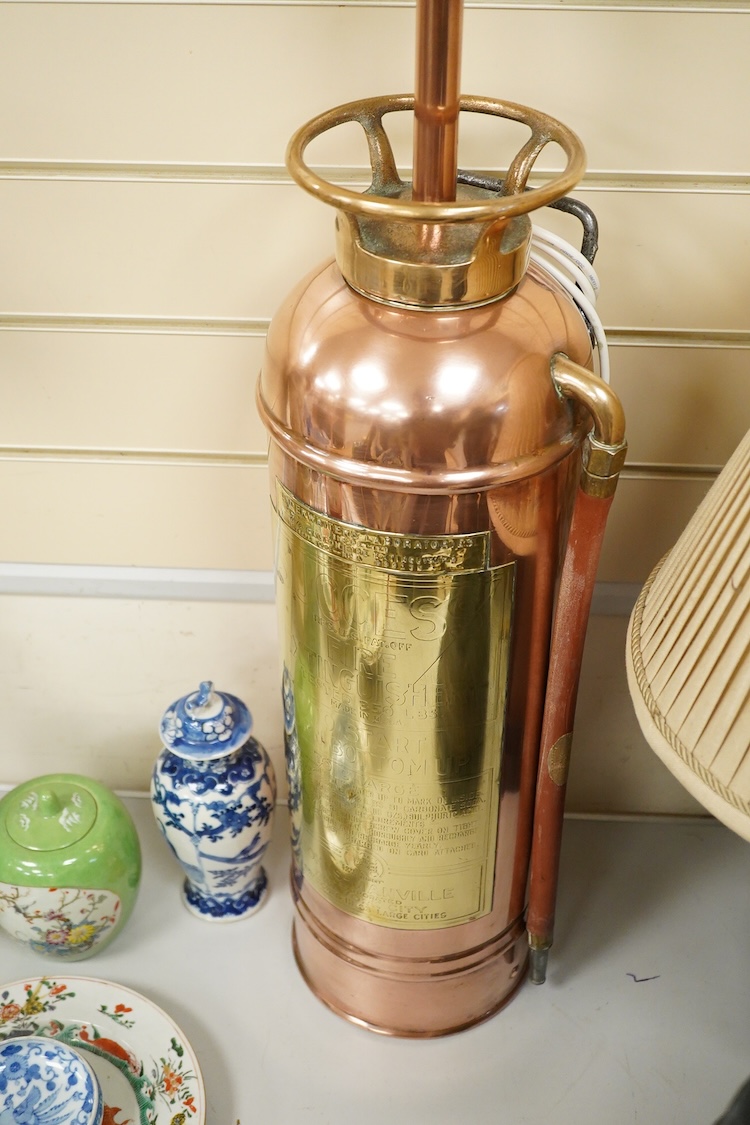 A copper fire extinguisher mounted as a table lamp, overall 93cm high